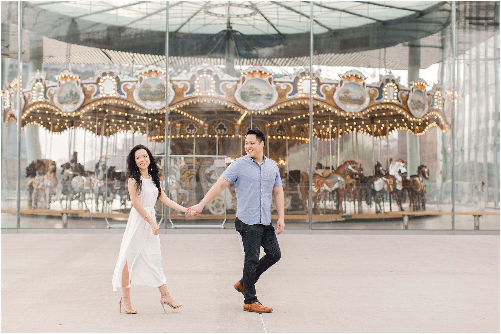 couple in front of Jane's carousel walking