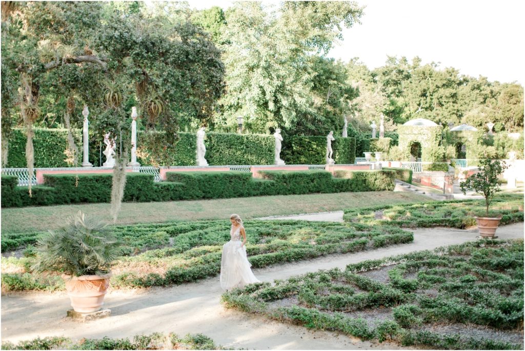 A bride walking through the gardens of Vizcaya museum and gardens